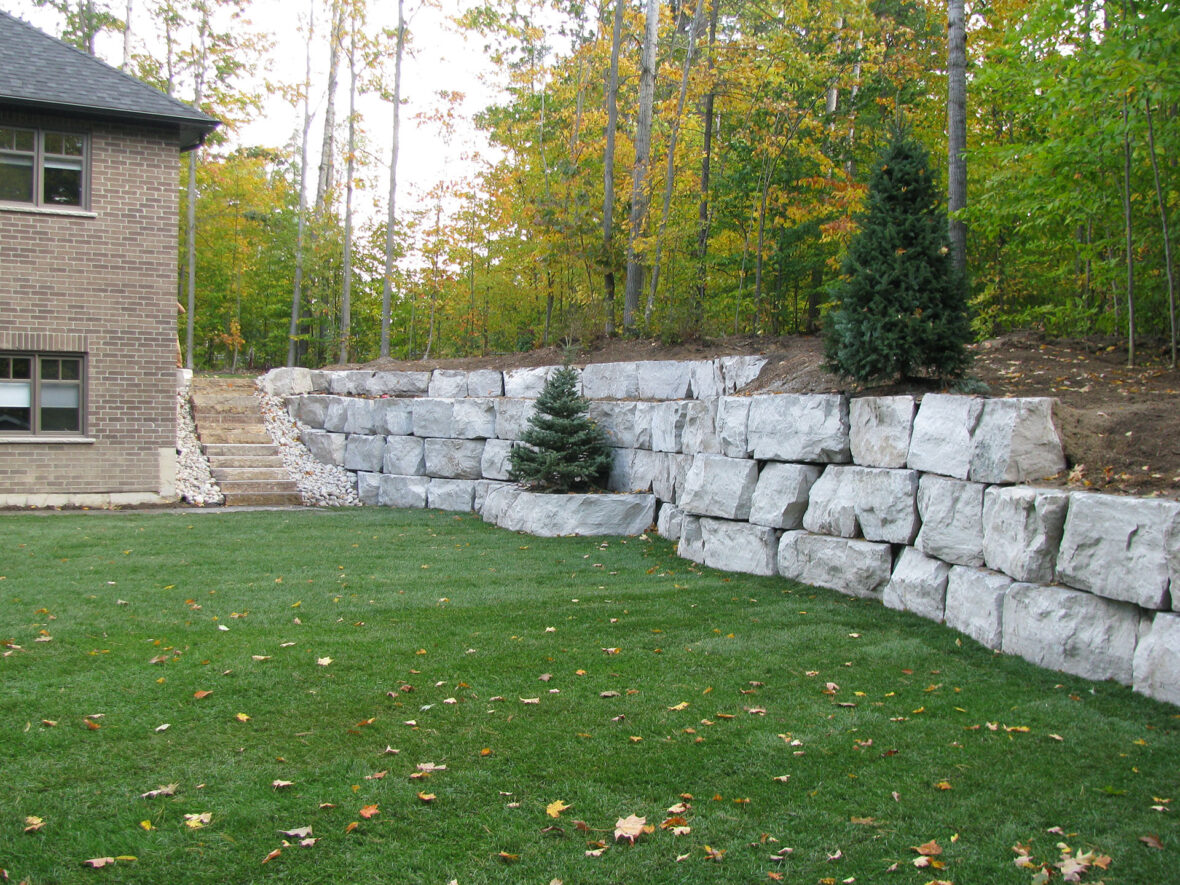 Armour Stone Retaining Wall, Armour Stone Steps, River Rock, Sod, Trees