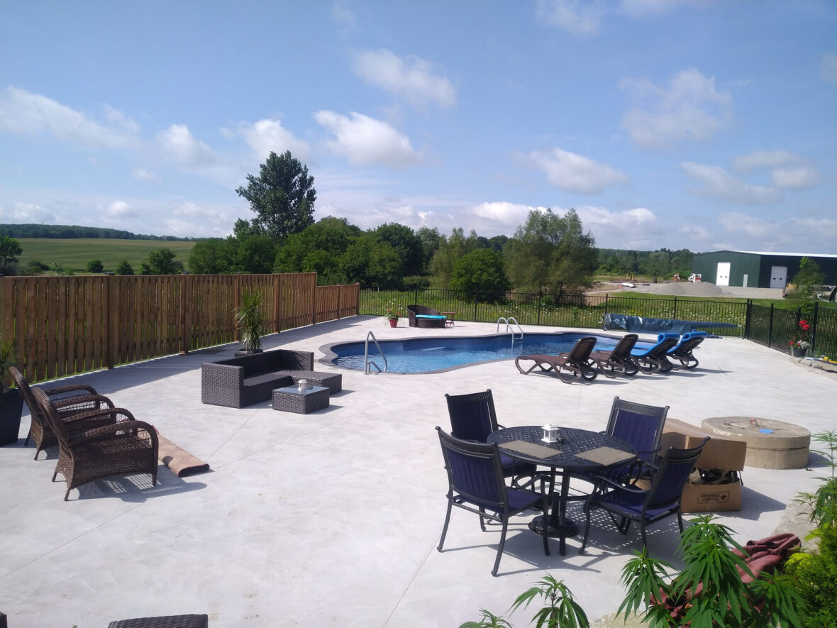 Wood and Wrought Iron Fence, Fiberglass Pool, Concrete Pad